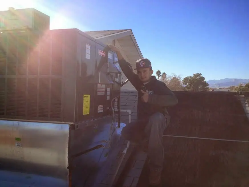 HVAC technician performing Air Duct Repair on a rooftop unit in Roseville